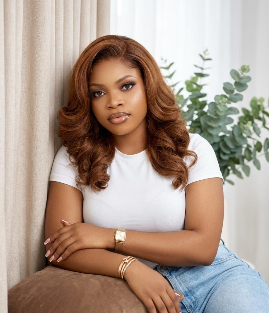 A woman with beautiful wavy copper brown human hair curls styled at Mibest Beauty, a top hair salon in Aba